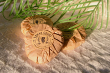 Load image into Gallery viewer, Two wrapped products with 'Lakay Goods' branding on a textured surface with green leaves.
